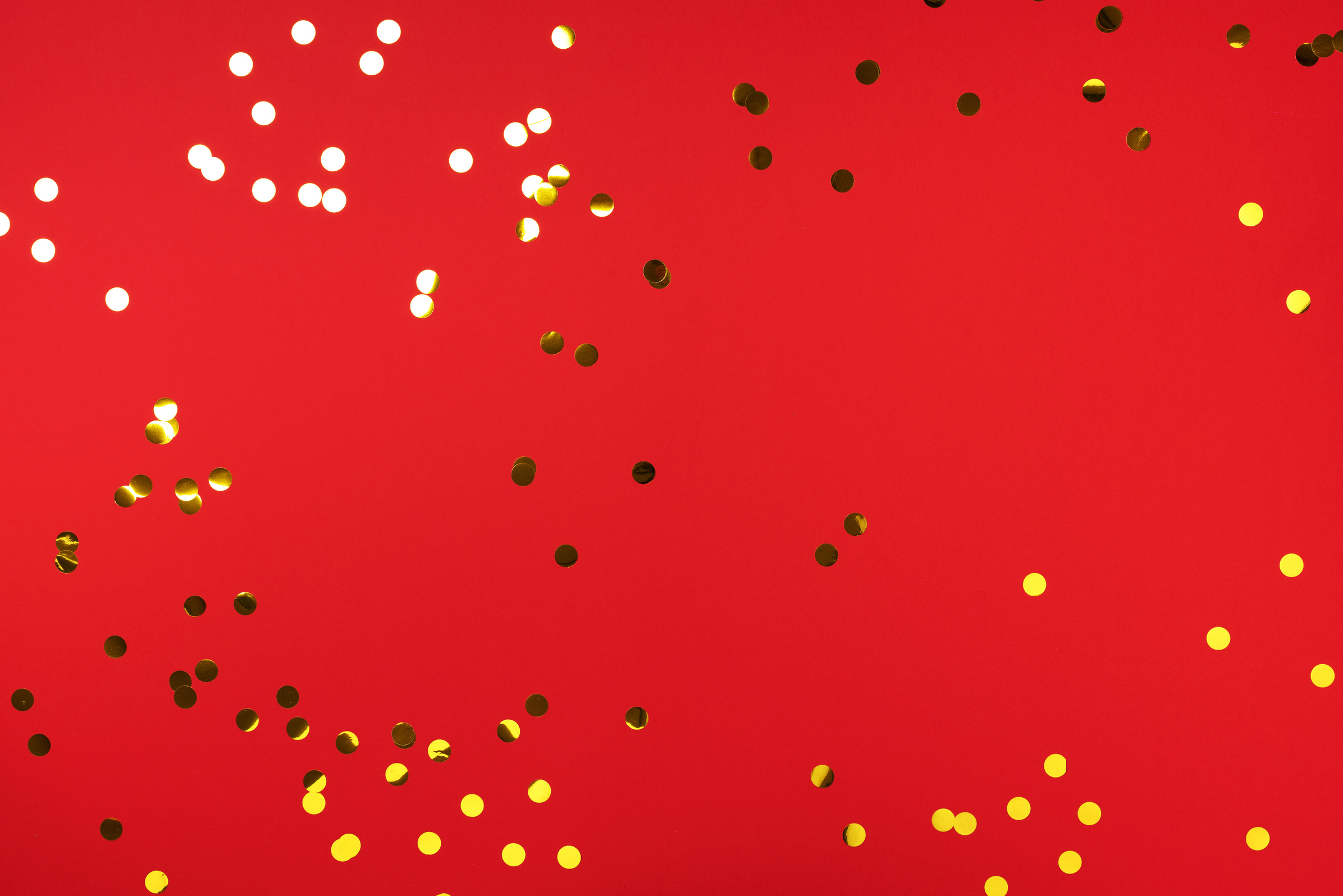 Golden Confetti on Red Background